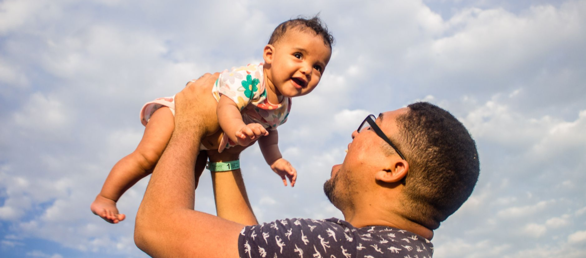 man carrying his baby
