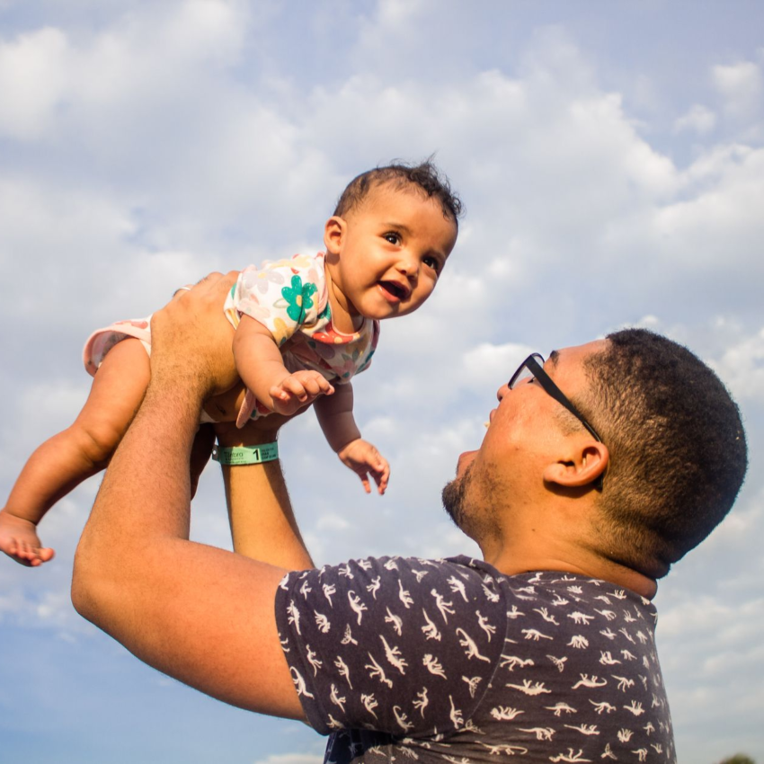 man carrying his baby